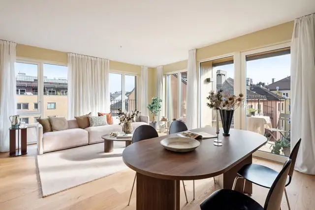 En innbydende oppholdsdel med naturlige soner for både spisebord og sofagruppe.